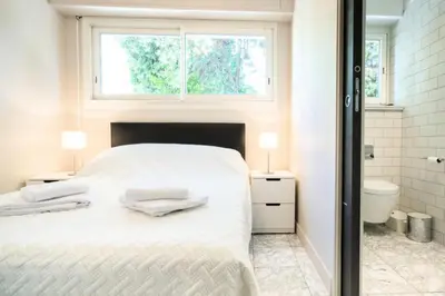 a white bedroom with a bed and a window at Résidence 3p Pointe Croisette, Au Calme, Plages à Pied - 3P pointe Croisette, au calme, plages à pied MAE-1883 in Cannes