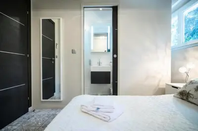 a bathroom with a bed with a sink and a mirror at Résidence 3p Pointe Croisette, Au Calme, Plages à Pied - 3P pointe Croisette, au calme, plages à pied MAE-1883 in Cannes