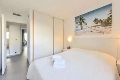 a bedroom with a white bed with towels on it at Résidence 4 Pièces Refait à Neuf, 3 Min De La Croisette - 4 pièces refait à neuf, 3 min de la Croisette MAE-1893 in Cannes