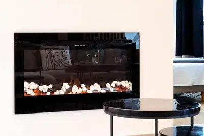 a fireplace in a living room with a table in front of it at Résidence 3p Cosy, 1 Min Des Plages Et 3min Du Centre-ville - 3P Cosy, 1 min des plages et 3min du centre-ville MAE-1903 in Cannes