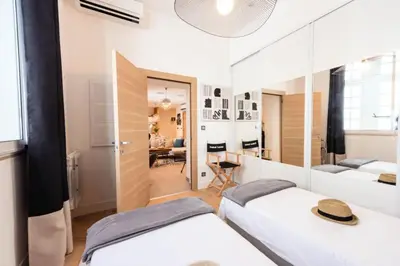 a bedroom with two beds and a living room at Résidence 3p Cosy, 1 Min Des Plages Et 3min Du Centre-ville - 3P Cosy, 1 min des plages et 3min du centre-ville MAE-1903 in Cannes