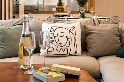 a pillow with a face on it sitting on a couch at Résidence 3p Cosy, 1 Min Des Plages Et 3min Du Centre-ville - 3P Cosy, 1 min des plages et 3min du centre-ville MAE-1903 in Cannes