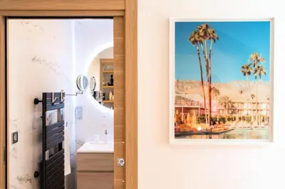 a bathroom with a painting of palm trees on the wall at Résidence 3p Cosy, 1 Min Des Plages Et 3min Du Centre-ville - 3P Cosy, 1 min des plages et 3min du centre-ville MAE-1903 in Cannes