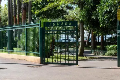 a green gate with a sign that reads square at Résidence 3p Cosy, 1 Min Des Plages Et 3min Du Centre-ville - 3P Cosy, 1 min des plages et 3min du centre-ville MAE-1903 in Cannes