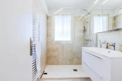 a white bathroom with a shower and a sink at Résidence 2p De Style Avec Terrasse, Plages Et Commerces à Pied - 2P de style avec terrasse, plages et commerces à pied MAE-1913 in Cannes