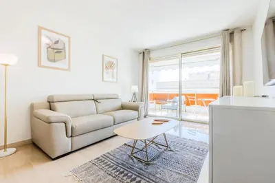 a living room with a couch and a table at Résidence 2p De Style Avec Terrasse, Plages Et Commerces à Pied - 2P de style avec terrasse, plages et commerces à pied MAE-1913 in Cannes