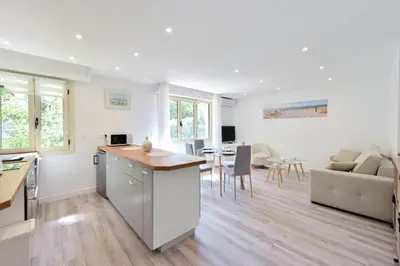 a kitchen and living room with a table and chairs at Résidence 2p En Centre Ville à 2min à Pied De La Croisette - 2P en centre ville à 2min à pied de la Croisette MAE-1923 in Cannes