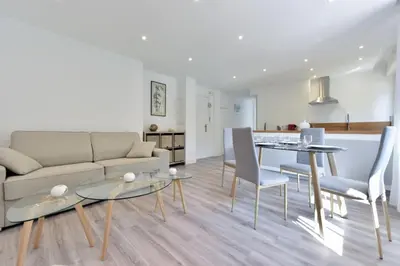 a living room with a couch and a table and chairs at Résidence 2p En Centre Ville à 2min à Pied De La Croisette - 2P en centre ville à 2min à pied de la Croisette MAE-1923 in Cannes