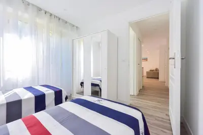 two beds in a room with a mirror at Résidence 2p En Centre Ville à 2min à Pied De La Croisette - 2P en centre ville à 2min à pied de la Croisette MAE-1923 in Cannes