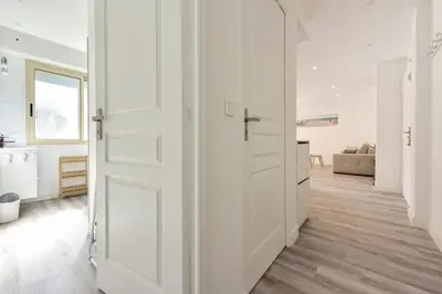 a hallway with white doors and a living room at Résidence 2p En Centre Ville à 2min à Pied De La Croisette - 2P en centre ville à 2min à pied de la Croisette MAE-1923 in Cannes
