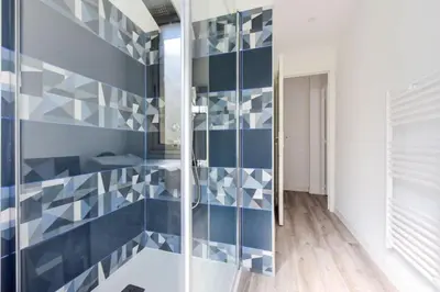 a bathroom with blue and white tiles on the wall at Résidence 2p En Centre Ville à 2min à Pied De La Croisette - 2P en centre ville à 2min à pied de la Croisette MAE-1923 in Cannes