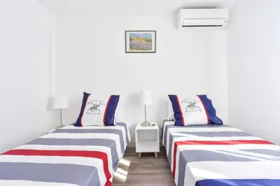 two beds sitting next to each other in a room at Résidence 2p En Centre Ville à 2min à Pied De La Croisette - 2P en centre ville à 2min à pied de la Croisette MAE-1923 in Cannes
