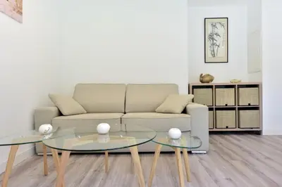 a living room with a couch and two glass tables at Résidence 2p En Centre Ville à 2min à Pied De La Croisette - 2P en centre ville à 2min à pied de la Croisette MAE-1923 in Cannes