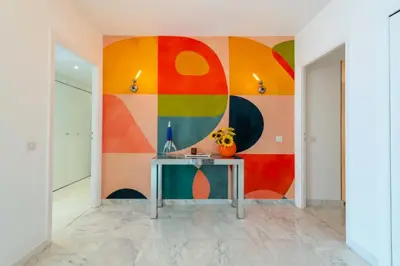 a wall mural in a hallway with a table at Résidence 3p Résidence De Standing, Avec Vue Mer & Piscine - 3P résidence de standing, avec vue mer & piscine MAE-1933 in Cannes