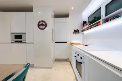 a kitchen with white cabinets and a counter top at Résidence 3p Résidence De Standing, Avec Vue Mer & Piscine - 3P résidence de standing, avec vue mer & piscine MAE-1933 in Cannes