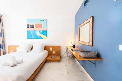 a bedroom with a bed and a desk with a mirror at Résidence 3p Résidence De Standing, Avec Vue Mer & Piscine - 3P résidence de standing, avec vue mer & piscine MAE-1933 in Cannes