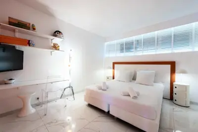 a white bedroom with a bed and a flat screen tv at Résidence 3p Résidence De Standing, Avec Vue Mer & Piscine - 3P résidence de standing, avec vue mer & piscine MAE-1933 in Cannes