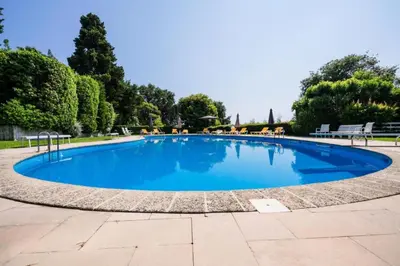 a large blue swimming pool in a park at Résidence 3p Résidence De Standing, Avec Vue Mer & Piscine - 3P résidence de standing, avec vue mer & piscine MAE-1933 in Cannes