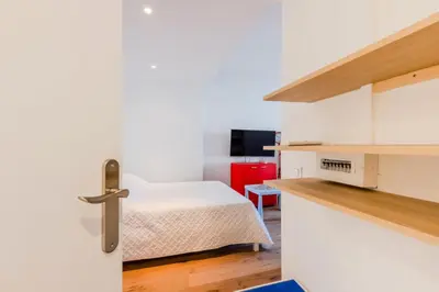 a room with a bed and a room with a door at Résidence 90m2 Sur La Croisette Avec Terrasse & Vue Mer - 90m2 sur la Croisette avec terrasse & vue mer MAE-1963 in Cannes