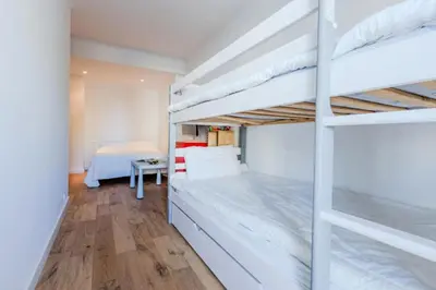 a bedroom with two bunk beds and a desk at Résidence 90m2 Sur La Croisette Avec Terrasse & Vue Mer - 90m2 sur la Croisette avec terrasse & vue mer MAE-1963 in Cannes