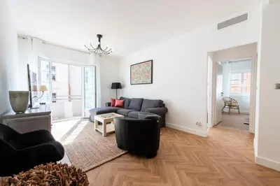 a living room with a couch and a table at Résidence 4p Carré D’or - Hyper Centre à Pied Des Plages - 4P Carré d’or - Hyper centre à pied des plages MAE-1973 in Cannes