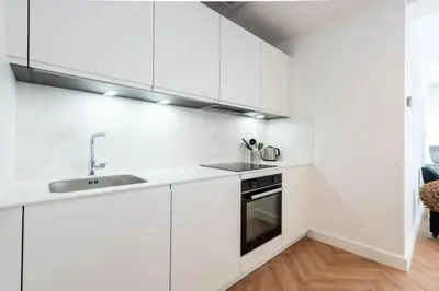 a white kitchen with a sink and a stove at Résidence 4p Carré D’or - Hyper Centre à Pied Des Plages - 4P Carré d’or - Hyper centre à pied des plages MAE-1973 in Cannes