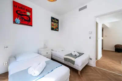 two beds in a room with white walls at Résidence 4p Carré D’or - Hyper Centre à Pied Des Plages - 4P Carré d’or - Hyper centre à pied des plages MAE-1973 in Cannes