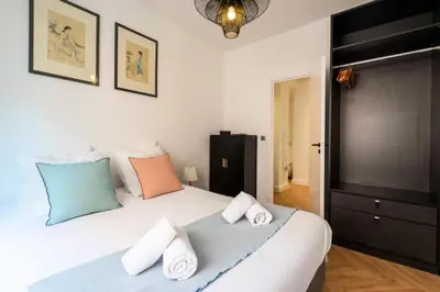 a bedroom with a large white bed with pillows at Résidence 4p Carré D’or - Hyper Centre à Pied Des Plages - 4P Carré d’or - Hyper centre à pied des plages MAE-1973 in Cannes
