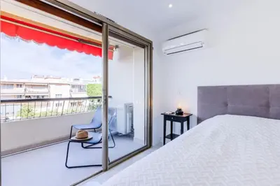 a bedroom with a bed and a balcony at Résidence 2 Pièces Cozy à 5 Minutes à Pied De La Croisette - 2 pièces cozy à 5 minutes à pied de la Croisette MAE-1983 in Cannes