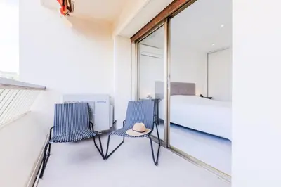 two chairs and a bed in a room with windows at Résidence 2 Pièces Cozy à 5 Minutes à Pied De La Croisette - 2 pièces cozy à 5 minutes à pied de la Croisette MAE-1983 in Cannes