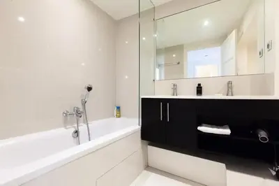 a bathroom with a tub and a sink and a mirror at Résidence 3p Moderne Et Cosy Aux Pieds De La Croisette ! - 3P moderne et cosy aux pieds de la Croisette ! MAE-2003 in Cannes
