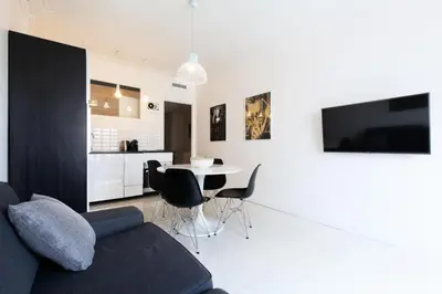 a living room with a couch and a table with chairs at Résidence 3p Moderne Et Cosy Aux Pieds De La Croisette ! - 3P moderne et cosy aux pieds de la Croisette ! MAE-2003 in Cannes