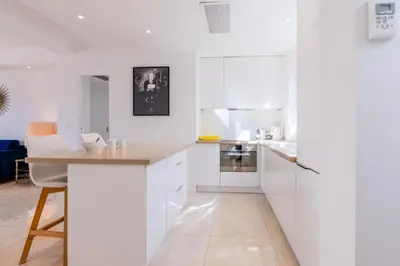 a kitchen with white cabinets and a wooden counter top at Résidence 3p De Style Avec Balcon à 3 Min De La Croisette - 3P de style avec balcon à 3 min de la Croisette MAE-2013 in Cannes