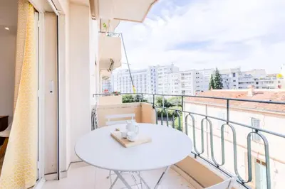 a white table on a balcony with a view at Résidence 3p De Style Avec Balcon à 3 Min De La Croisette - 3P de style avec balcon à 3 min de la Croisette MAE-2013 in Cannes