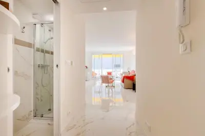 a white bathroom with a shower and a dining room at Résidence 2p De Style Avec Terrasse, Domaine Privé Palm Beach - 2P de style avec terrasse, domaine privé Palm Beach MAE-2053 in Cannes