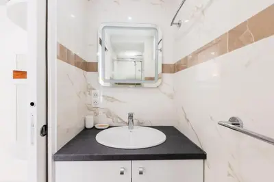 a bathroom with a sink and a mirror at Résidence 2p De Style Avec Terrasse, Domaine Privé Palm Beach - 2P de style avec terrasse, domaine privé Palm Beach MAE-2053 in Cannes