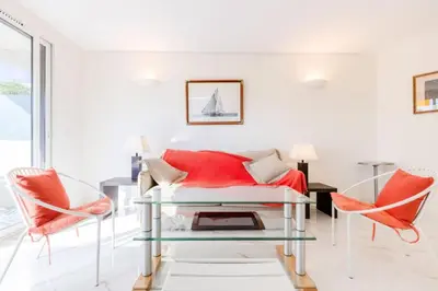 a living room with a red couch and two chairs at Résidence 2p De Style Avec Terrasse, Domaine Privé Palm Beach - 2P de style avec terrasse, domaine privé Palm Beach MAE-2053 in Cannes