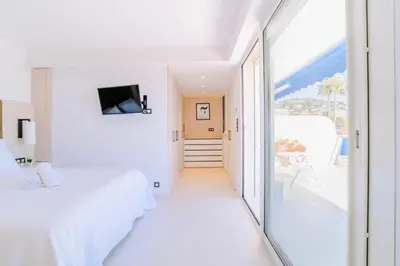 a white room with a bed and a large window at Résidence 2p Avec Terrasse Vue Mer & Parking, 2min Des Plages - 2P avec terrasse vue mer & parking, 2min des plages MAE-2063 in Cannes