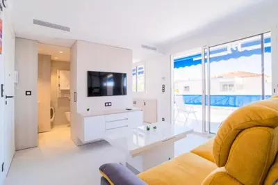a living room with a couch and a tv at Résidence 2p Avec Terrasse Vue Mer & Parking, 2min Des Plages - 2P avec terrasse vue mer & parking, 2min des plages MAE-2063 in Cannes