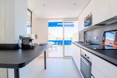 a kitchen with white cabinets and a black counter top at Résidence 2p Avec Terrasse Vue Mer & Parking, 2min Des Plages - 2P avec terrasse vue mer & parking, 2min des plages MAE-2063 in Cannes