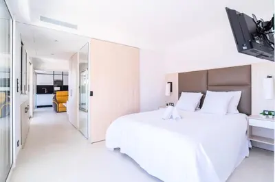 a white bedroom with a large white bed at Résidence 2p Avec Terrasse Vue Mer & Parking, 2min Des Plages - 2P avec terrasse vue mer & parking, 2min des plages MAE-2063 in Cannes