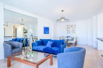 a living room with blue chairs and a glass table at Résidence 3p à 100m Des Plages, Terrasse Et Parking - 3P à 100m des plages, terrasse et parking MAE-2073 in Cannes
