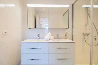 a white bathroom with a sink and a shower at Résidence 3p à 100m Des Plages, Terrasse Et Parking - 3P à 100m des plages, terrasse et parking MAE-2073 in Cannes