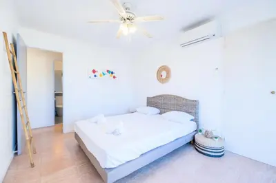 a white bedroom with a bed and a ceiling fan at Résidence 3p à 100m Des Plages, Terrasse Et Parking - 3P à 100m des plages, terrasse et parking MAE-2073 in Cannes