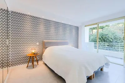 a bedroom with a bed and a large window at Résidence 4p De 96m² Sur Les Hauteurs De Cannes - 4P de 96m² sur les hauteurs de Cannes MAE-2083 in Cannes