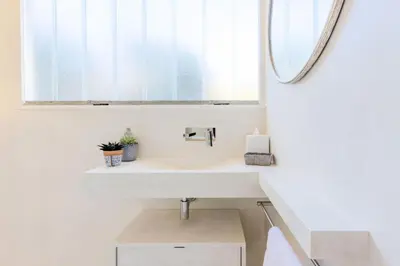 a bathroom with a white sink and a mirror at Résidence 4p De 96m² Sur Les Hauteurs De Cannes - 4P de 96m² sur les hauteurs de Cannes MAE-2083 in Cannes