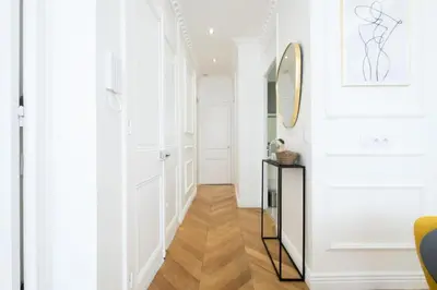 a hallway with white walls and a mirror at Résidence 4p Au Cœur Du Centre Ville - 5 Min Palais & Plages - 4P au cœur du centre ville - 5 min Palais & Plages MAE-2093 in Cannes