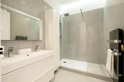 a white bathroom with a shower and a sink at Résidence 4p Au Cœur Du Centre Ville - 5 Min Palais & Plages - 4P au cœur du centre ville - 5 min Palais & Plages MAE-2093 in Cannes