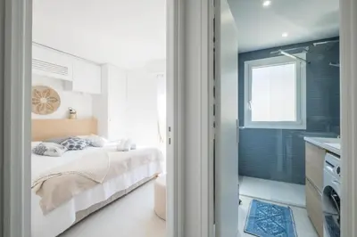 a small bedroom with a bed and a bathroom at Résidence 3p De Style à Deux Pas De La Croisette & Commerces - 3P de style à deux pas de la Croisette & commerces MAE-2103 in Cannes