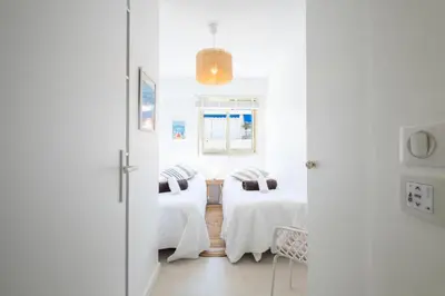 two beds in a room with white walls at Résidence 3p De Style à Deux Pas De La Croisette & Commerces - 3P de style à deux pas de la Croisette & commerces MAE-2103 in Cannes